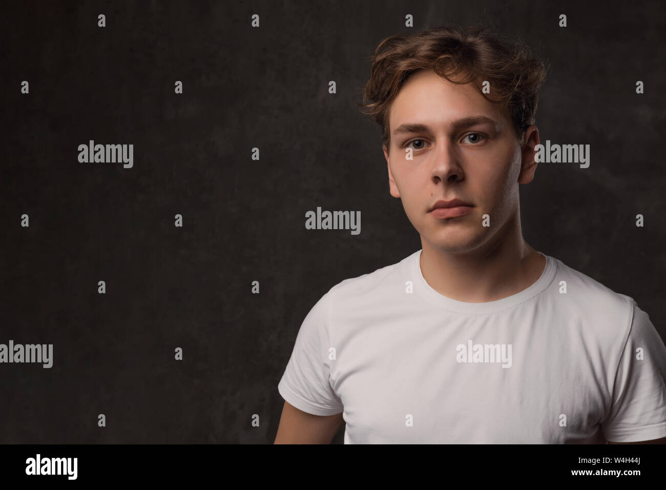 Handsome Young Man With A Stylish Haircut In A White Shirt On