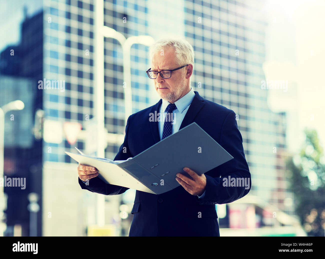senior businessman with ring binder folder in city Stock Photo