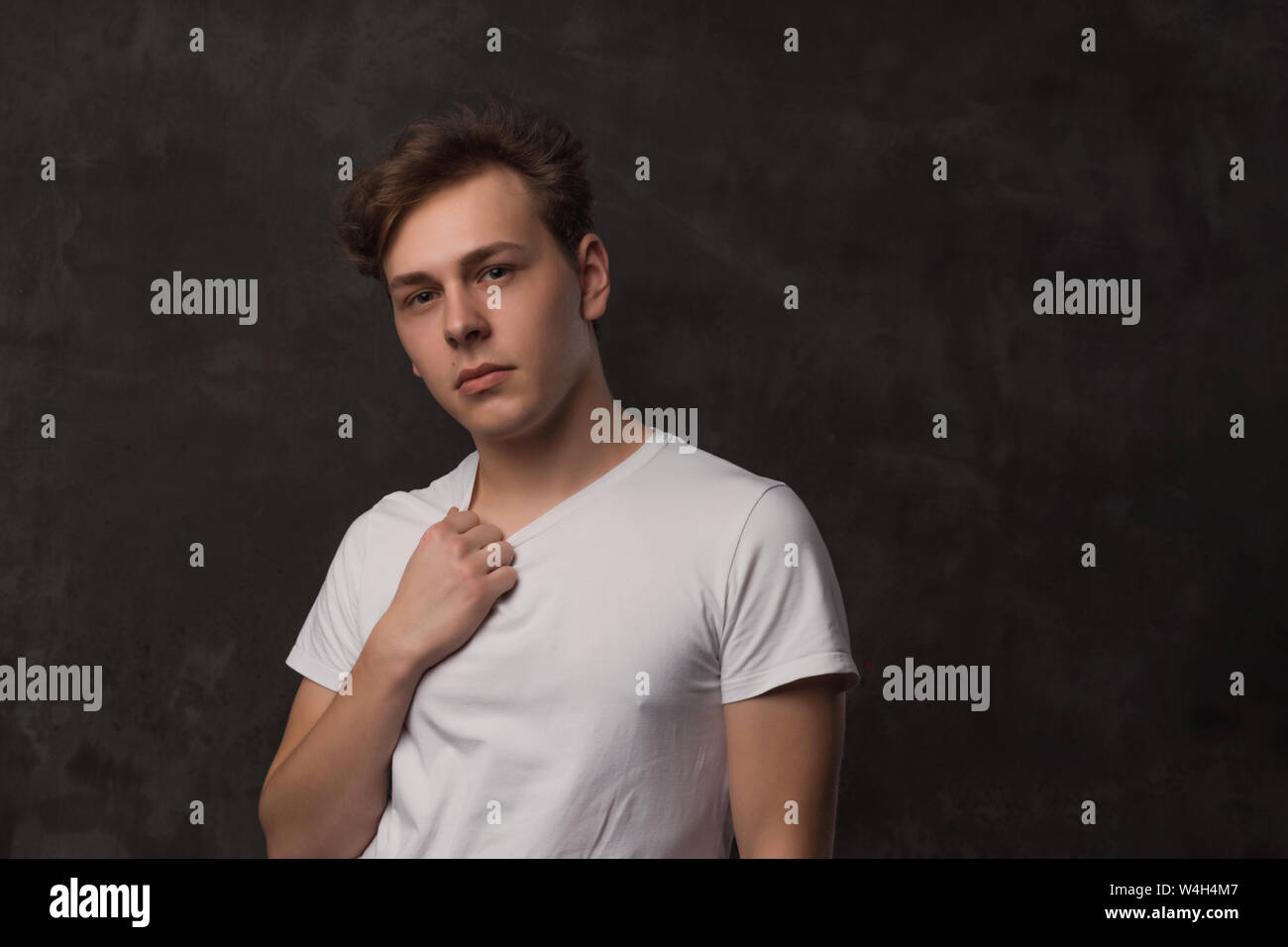 Handsome Young Man With A Stylish Haircut In A White Shirt On
