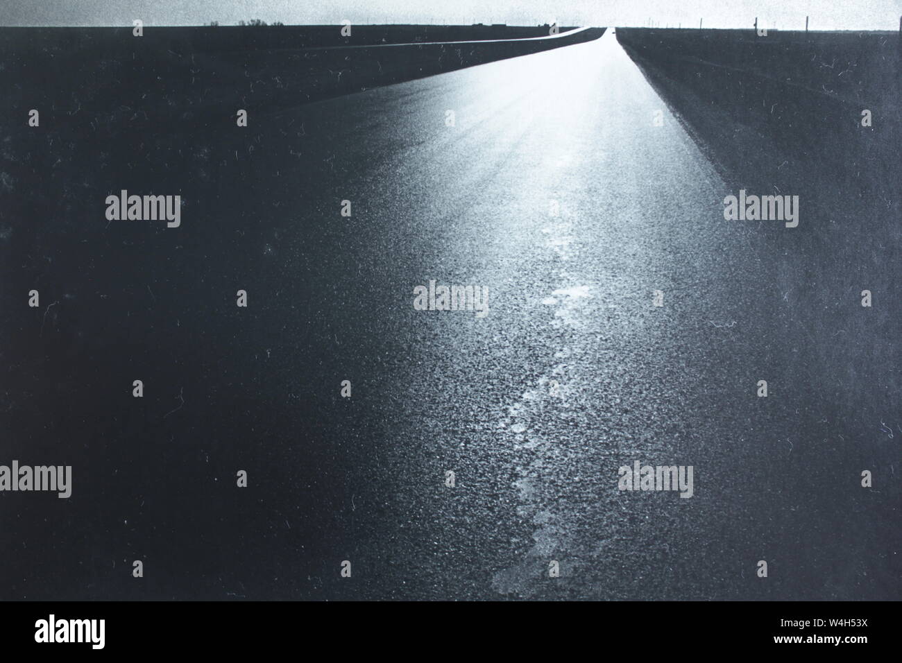 Fine black and white art photography from the 1970s of a long and lonely highway Stock Photo