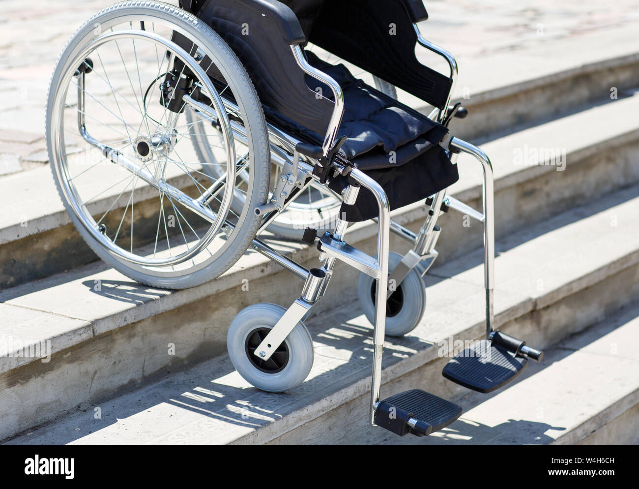 Wheelchair near the steps outdoors in the park Stock Photo Alamy