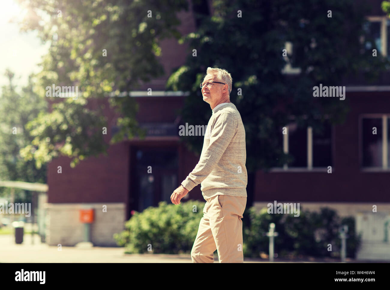 Old man walking along street hi-res stock photography and images - Alamy