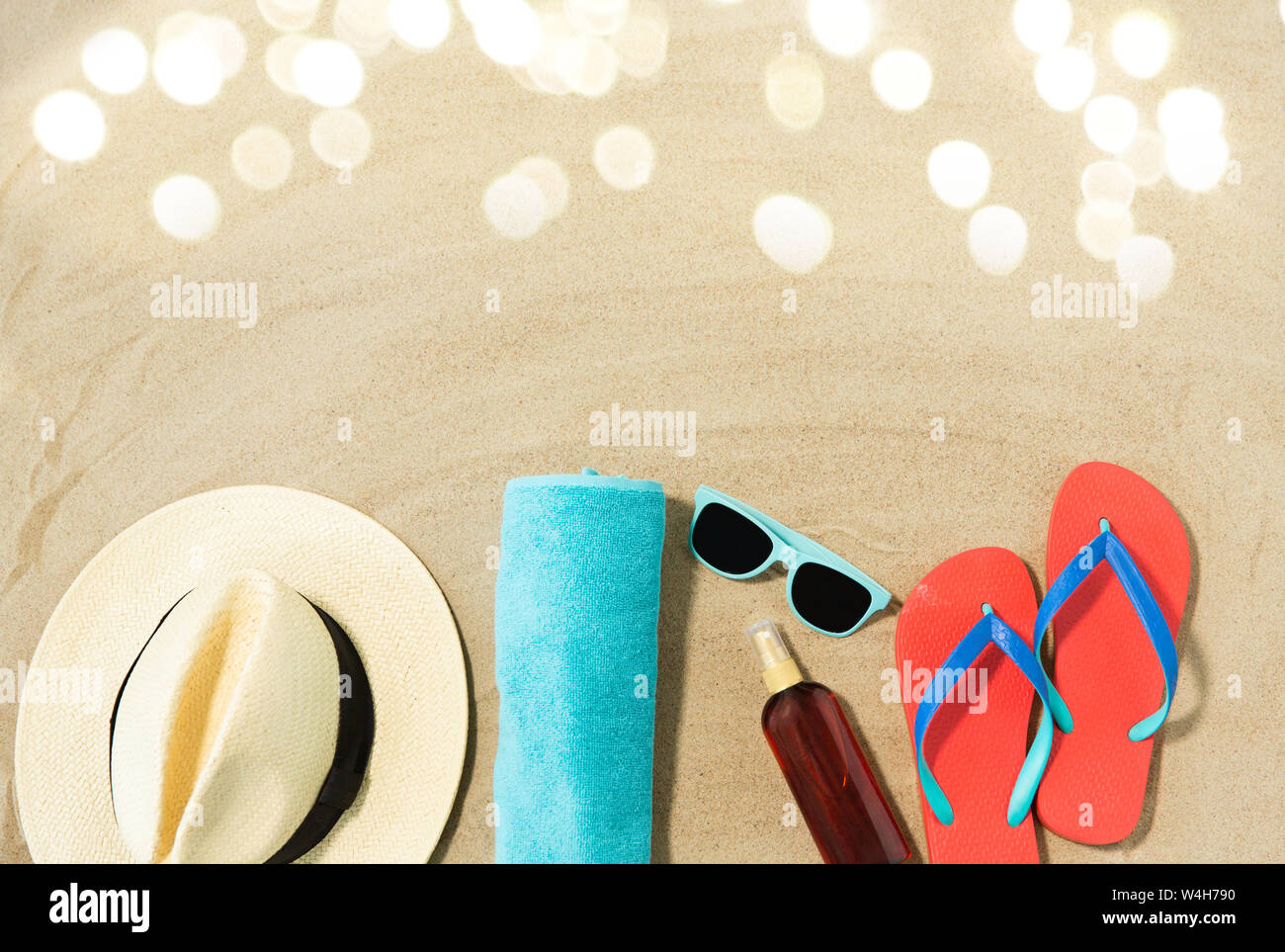 straw hat, flip flops and sunglasses on beach sand Stock Photo - Alamy