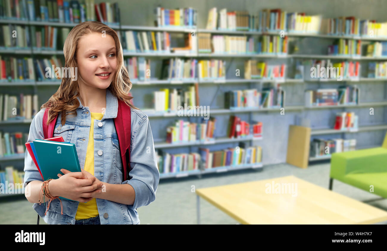 teenage student girl with books at school library Stock Photo - Alamy