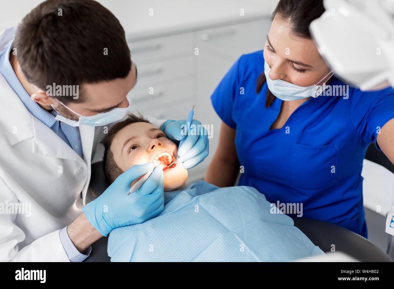 dentist checking for kid teeth at dental clinic Stock Photo Alamy