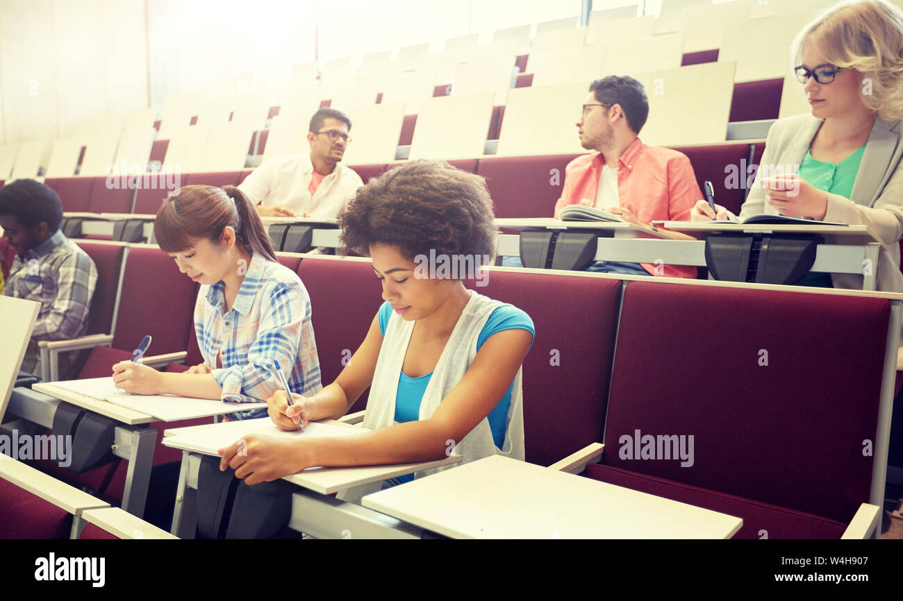 Group Of Students With Notebooks At Lecture Hall Stock Photo - Alamy