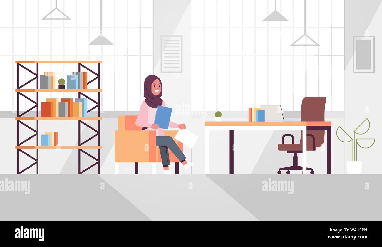arabic businesswoman sitting at workplace desk arab business woman holding paper documents