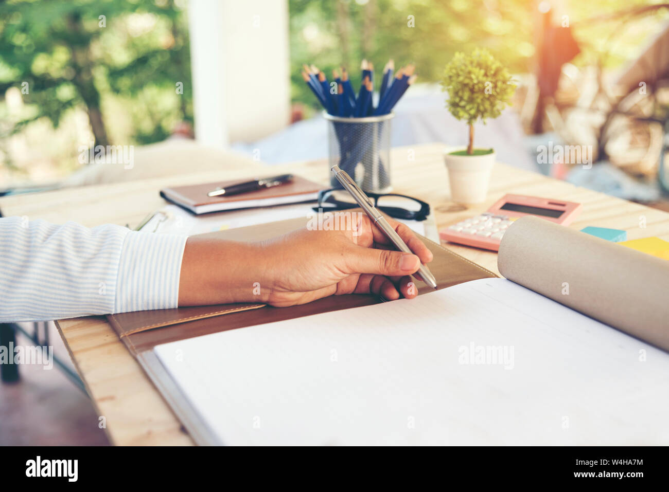 Business woman hands writing on notebook. Work outdoor. Stock Photo