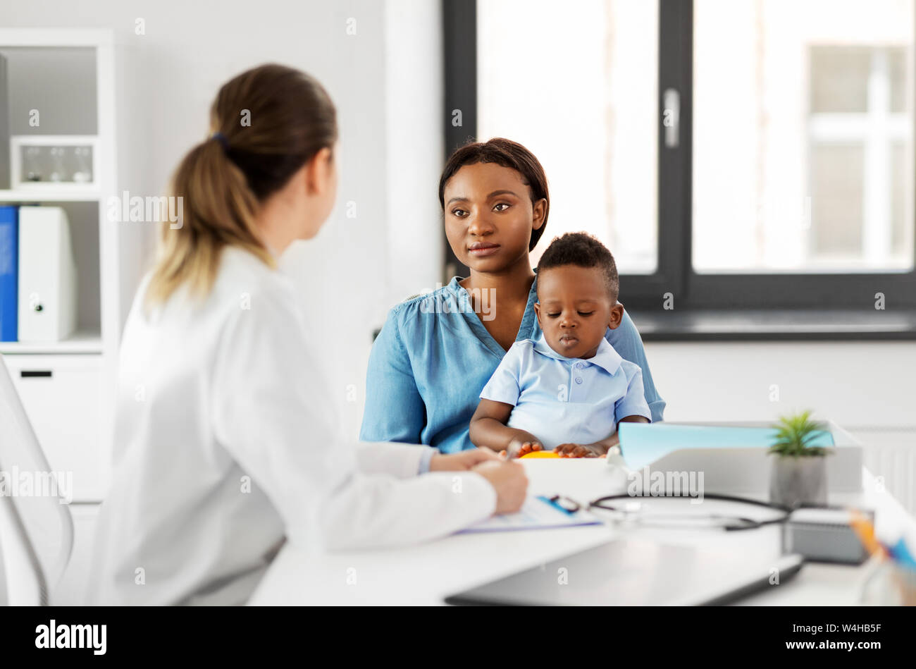 mother with baby son and doctor at clinic Stock Photo - Alamy