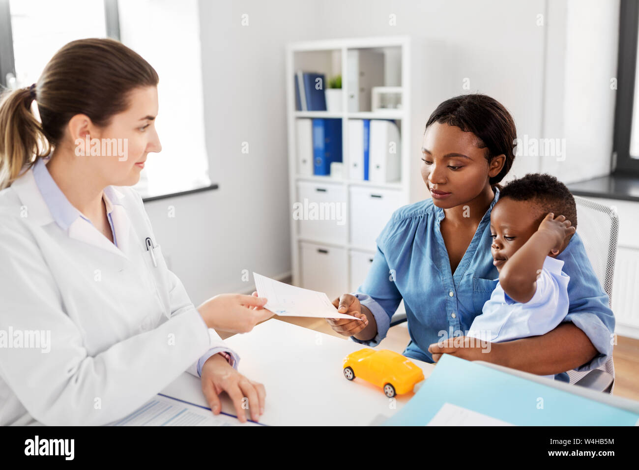mother with baby son and doctor at clinic Stock Photo - Alamy