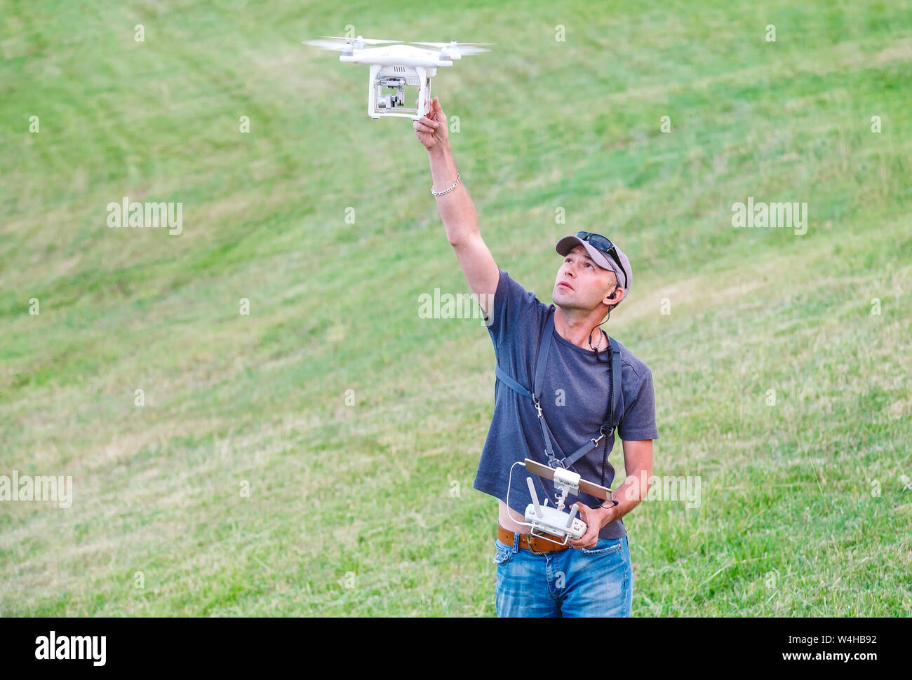 Young Man watching and navigating a flying drone. Stock Photo