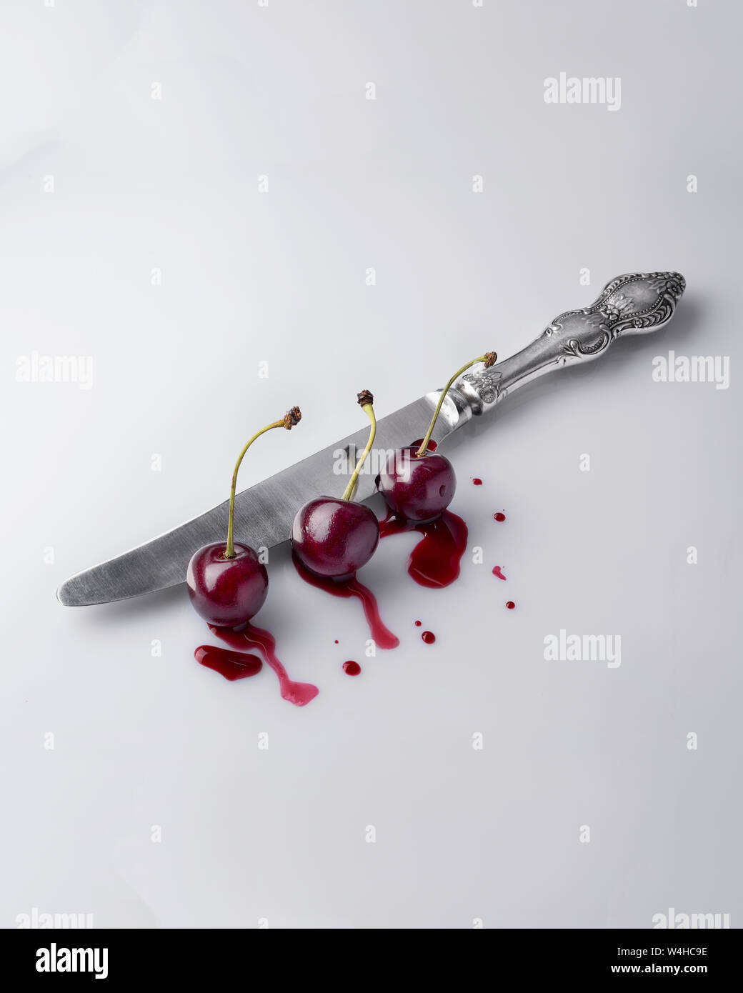 Natural cherry cuts the old knife oreginalny concept. View from the top and side. Stock Photo