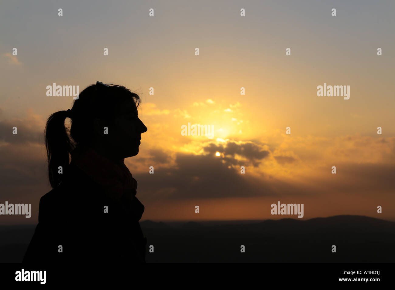 Silhouette of a woman profile at sunset Stock Photo - Alamy