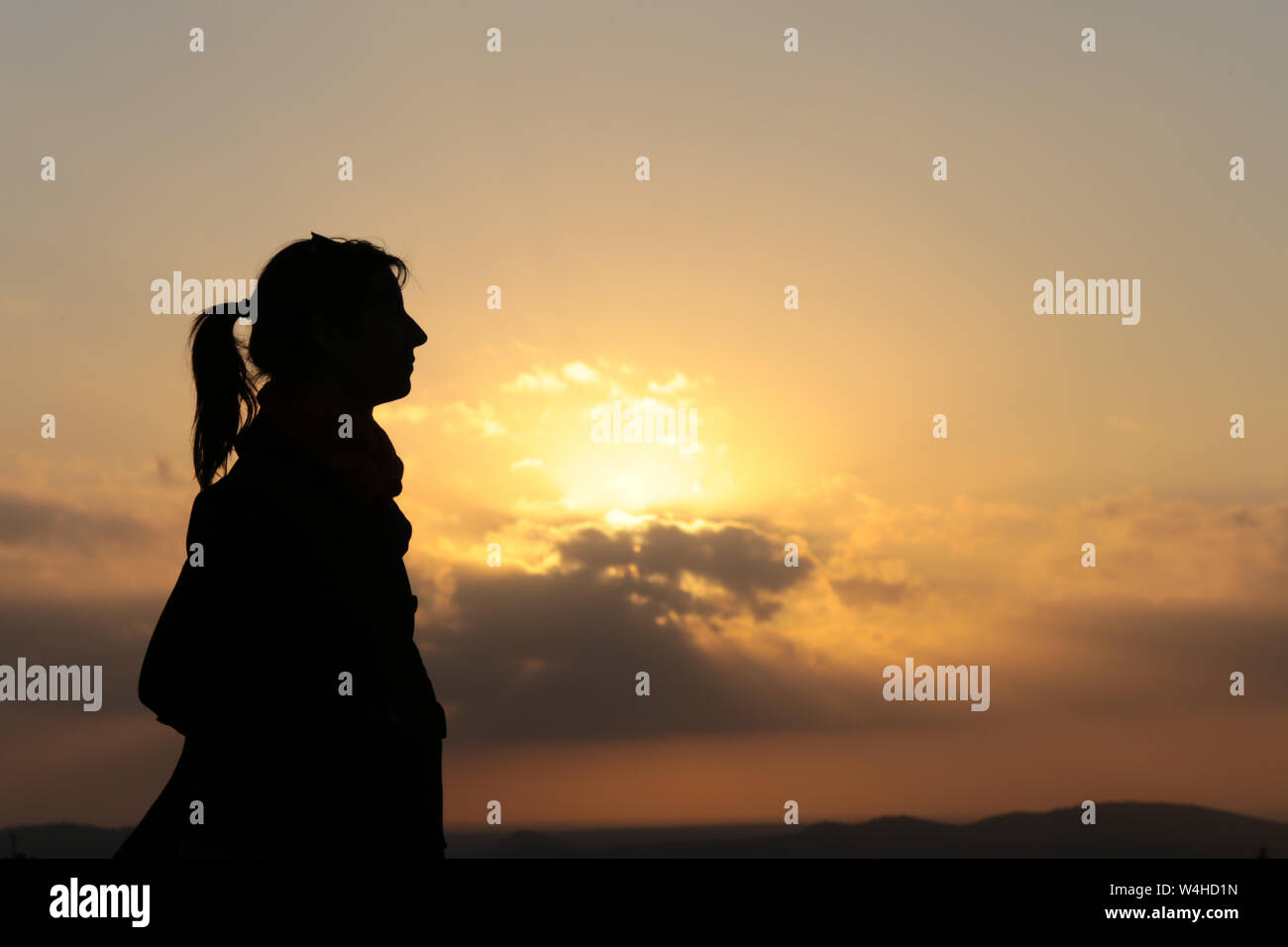 Silhouette of a woman profile at sunset Stock Photo - Alamy