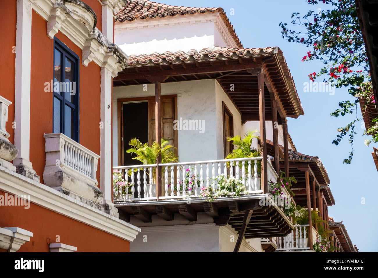 Colombia Cartagena Old Walled City Center centre colonial architecture facade wood balcony spindle railing ornamental planters residential apar Stock Photo