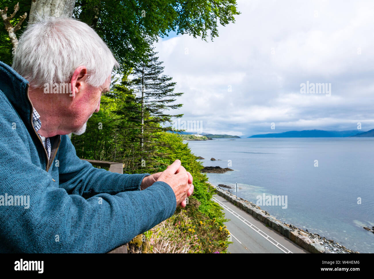 Senior man looking to Sabhal Mòr Ostaig, Sleat Peninsula, Isle of Skye, Inner Hebrides, Scotland, Uk Stock Photo