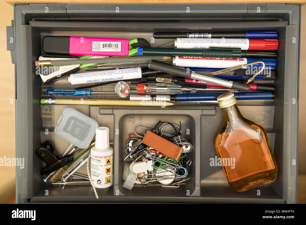 Symbol image addiction, alcohol, liquor, hidden at work, in the office drawer, Stock Photo