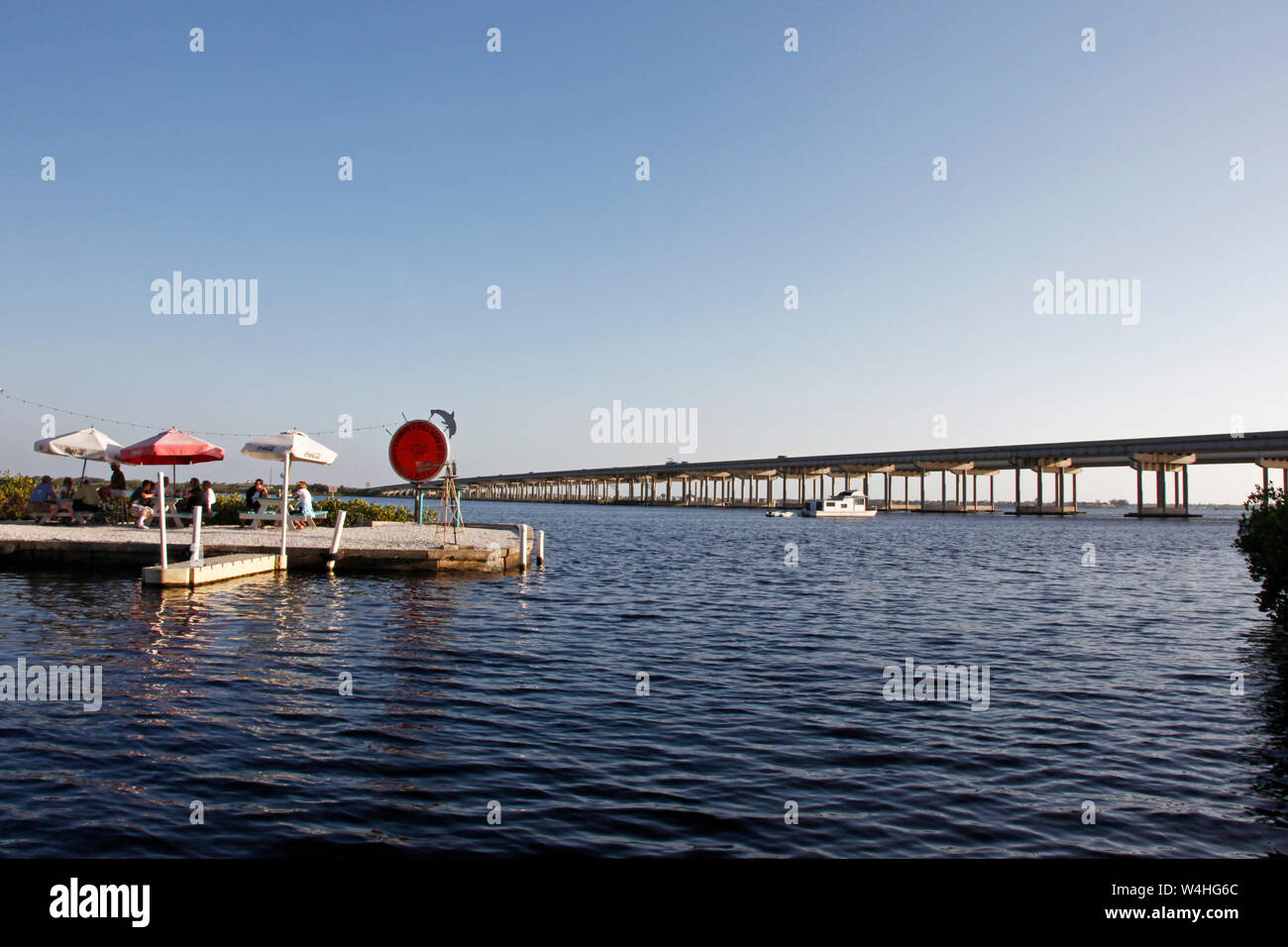 Ellenton, Florida- April 6, 2010: Patio tables with umbrellas on an evening at Woody Roos near the Trooper bridge Stock Photo