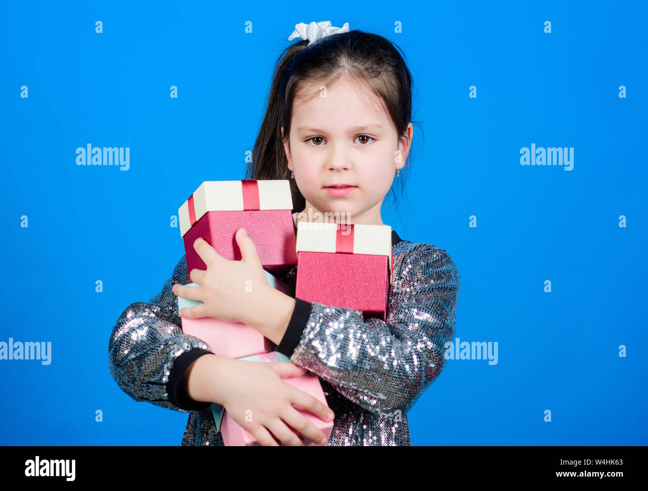 Special happens every day. Girl with gift boxes blue background. Black friday. Shopping day. Child carry lot gift boxes. Surprise gift box. Birthday wish list. World of happiness. Only for me. Stock Photo