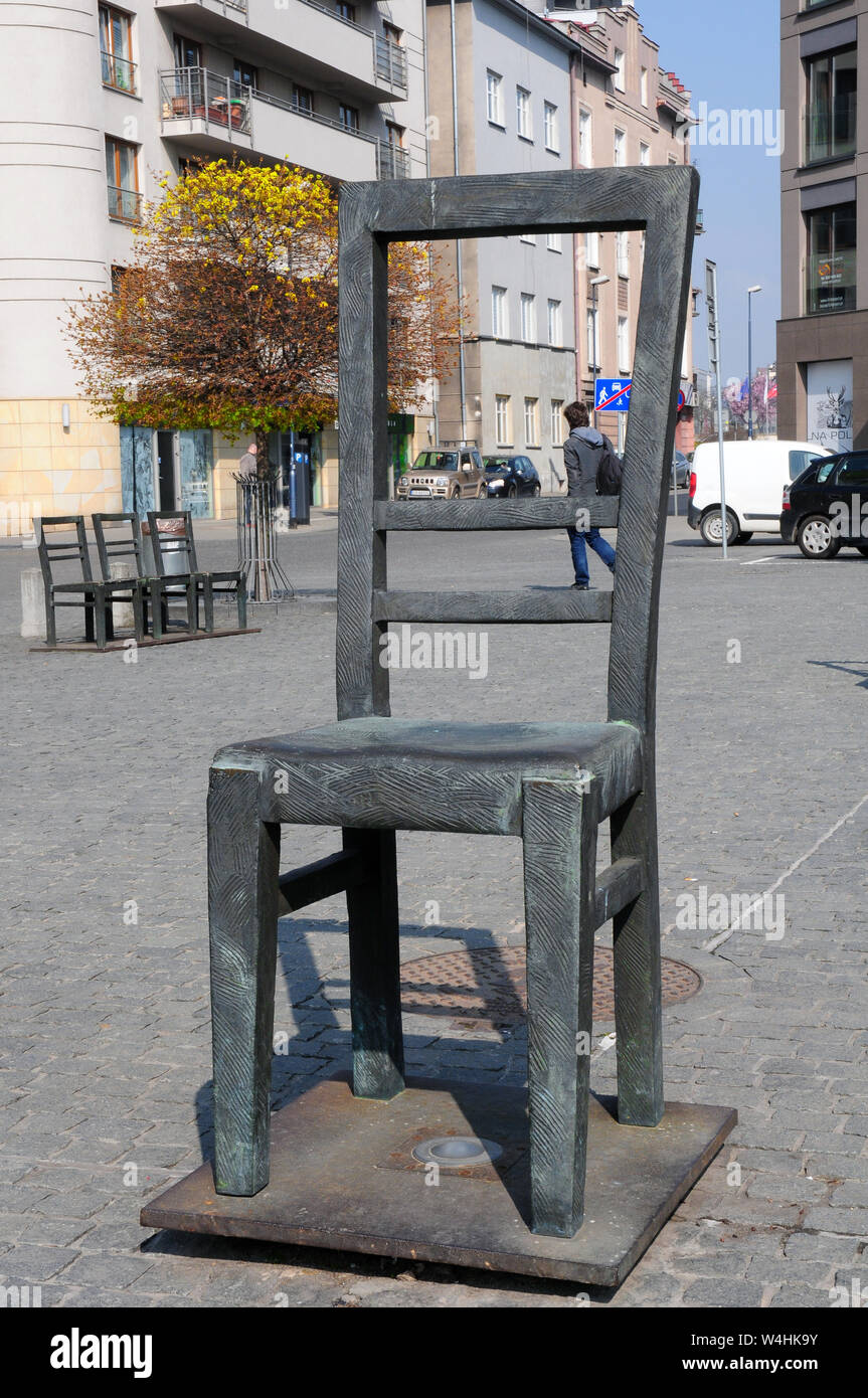 large chair, and three small chairs, (representing children) in the  monument ghetto Heroes Square, Krakow, Little Poland Stock Photo - Alamy