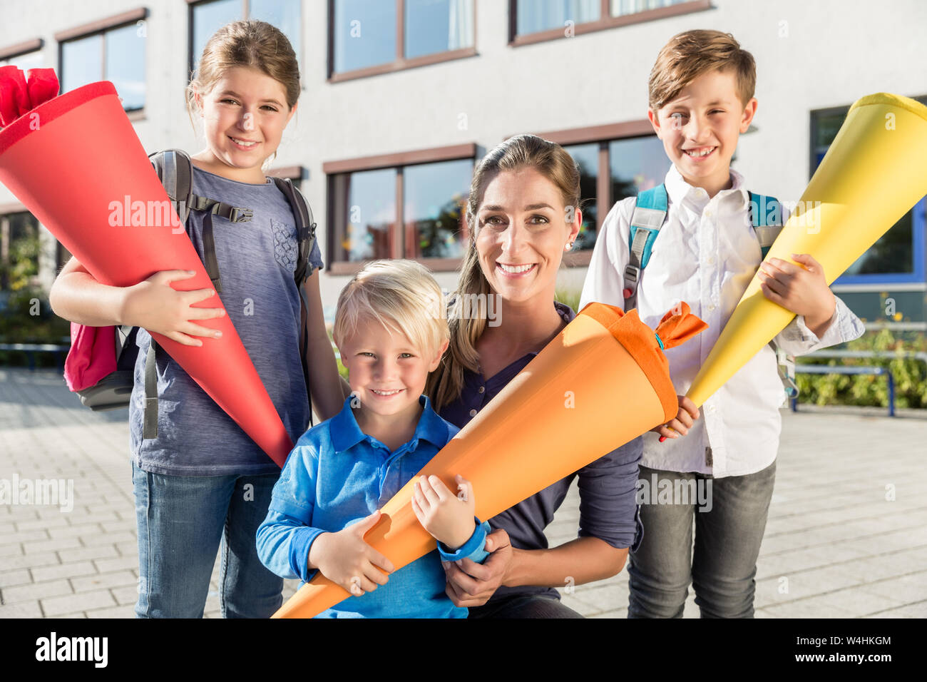 Woman and kids at enrollment day with school cones Stock Photo