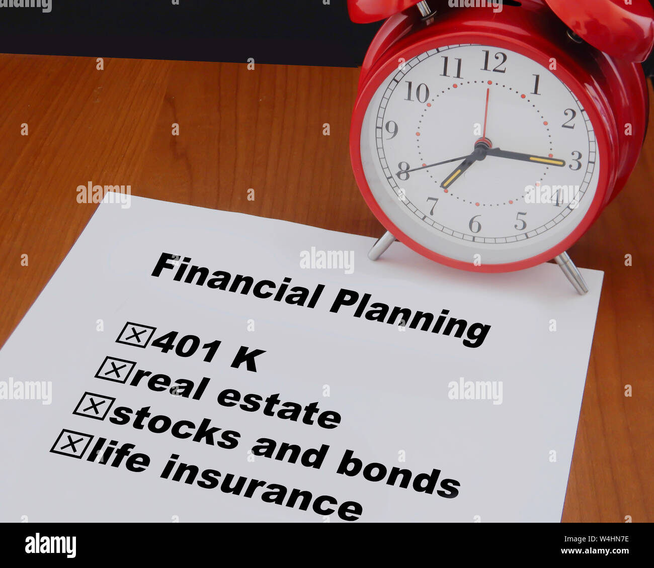 Calaculator and clock symbolize the importance of setting up a financial portfolio before it is too late . Stock Photo
