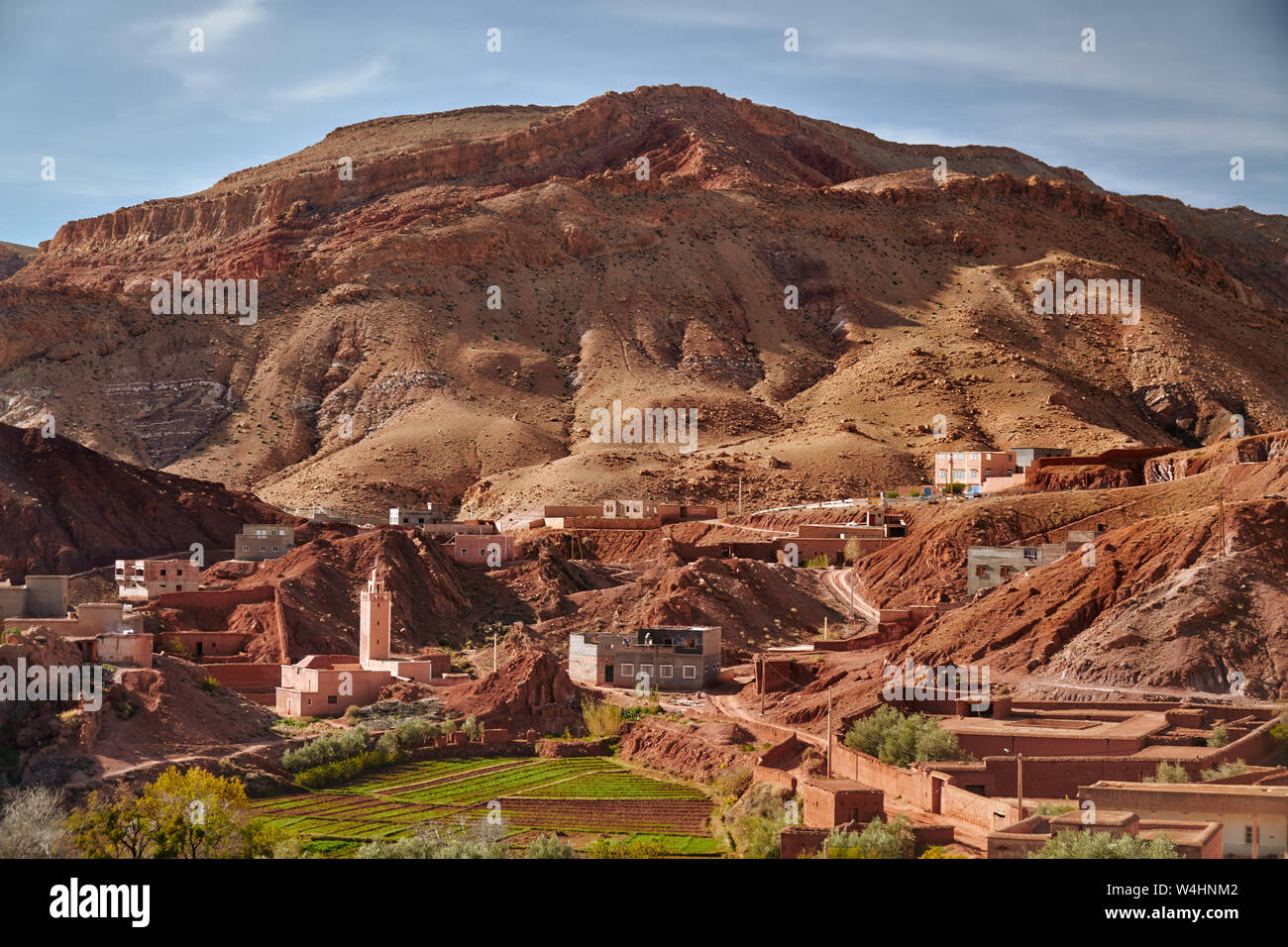 Red rocks and mosque in a rural town of Dades du Gorges canyon in ...