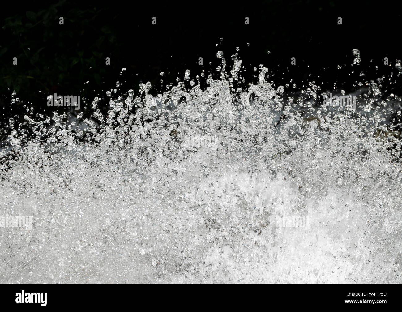 Splashes of water on a black background. Water splash texture Stock Photo -  Alamy