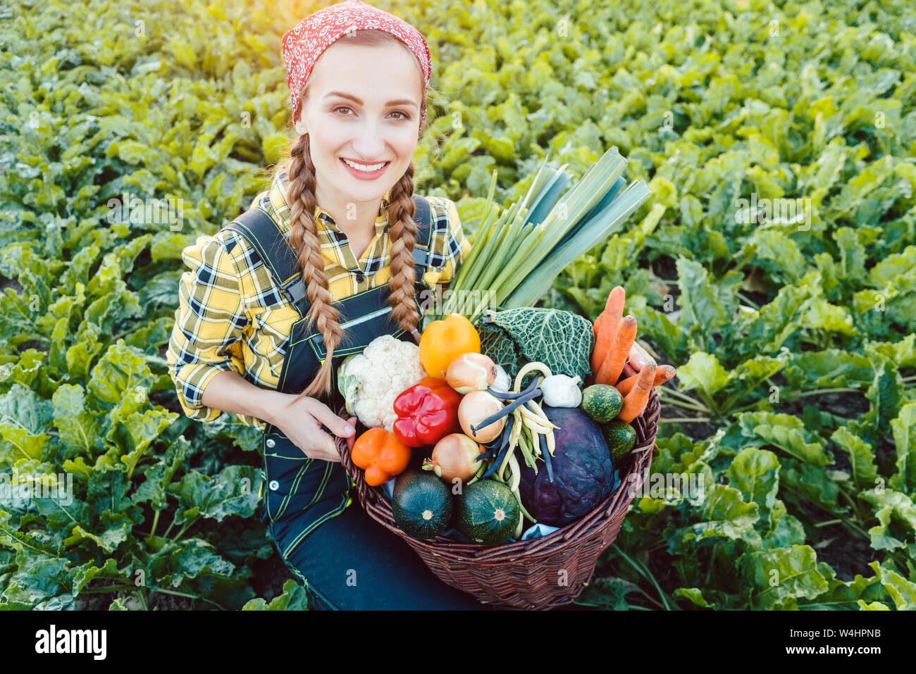 Farmer woman in a field offering organic vegetables Stock Photo - Alamy