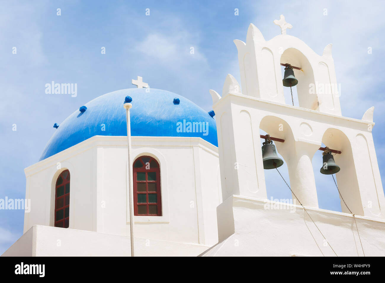 Famous beautiful Orthodox church with blue dome in Oia on Santorini island, Greece Stock Photo