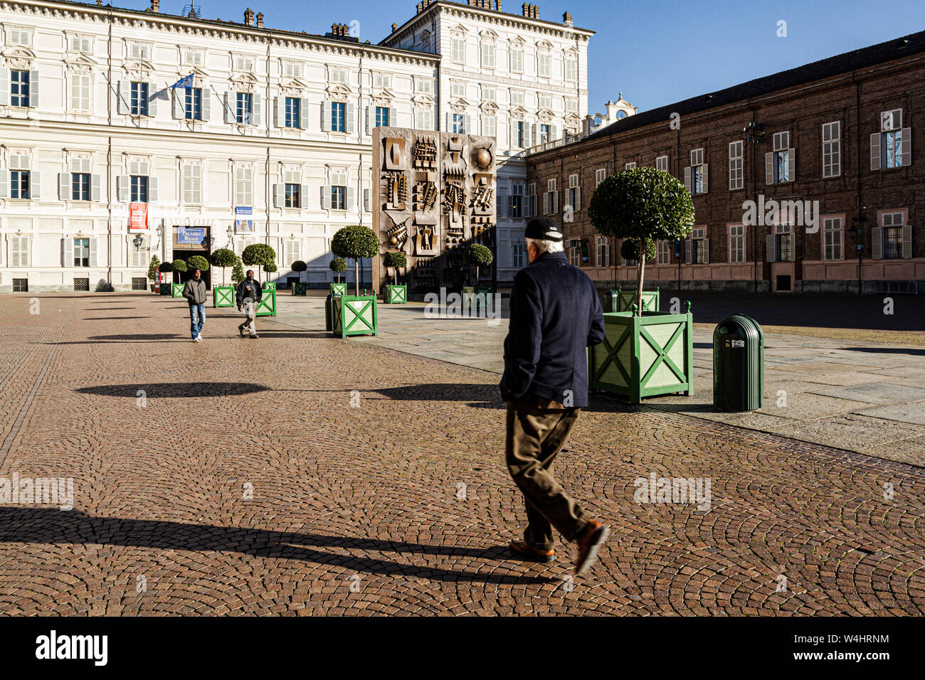 People walking in front of Palazzo Reale (Royal Palace) at Piazza Reale (Royal Square). Turin, Province of Turin, Italy. Stock Photo
