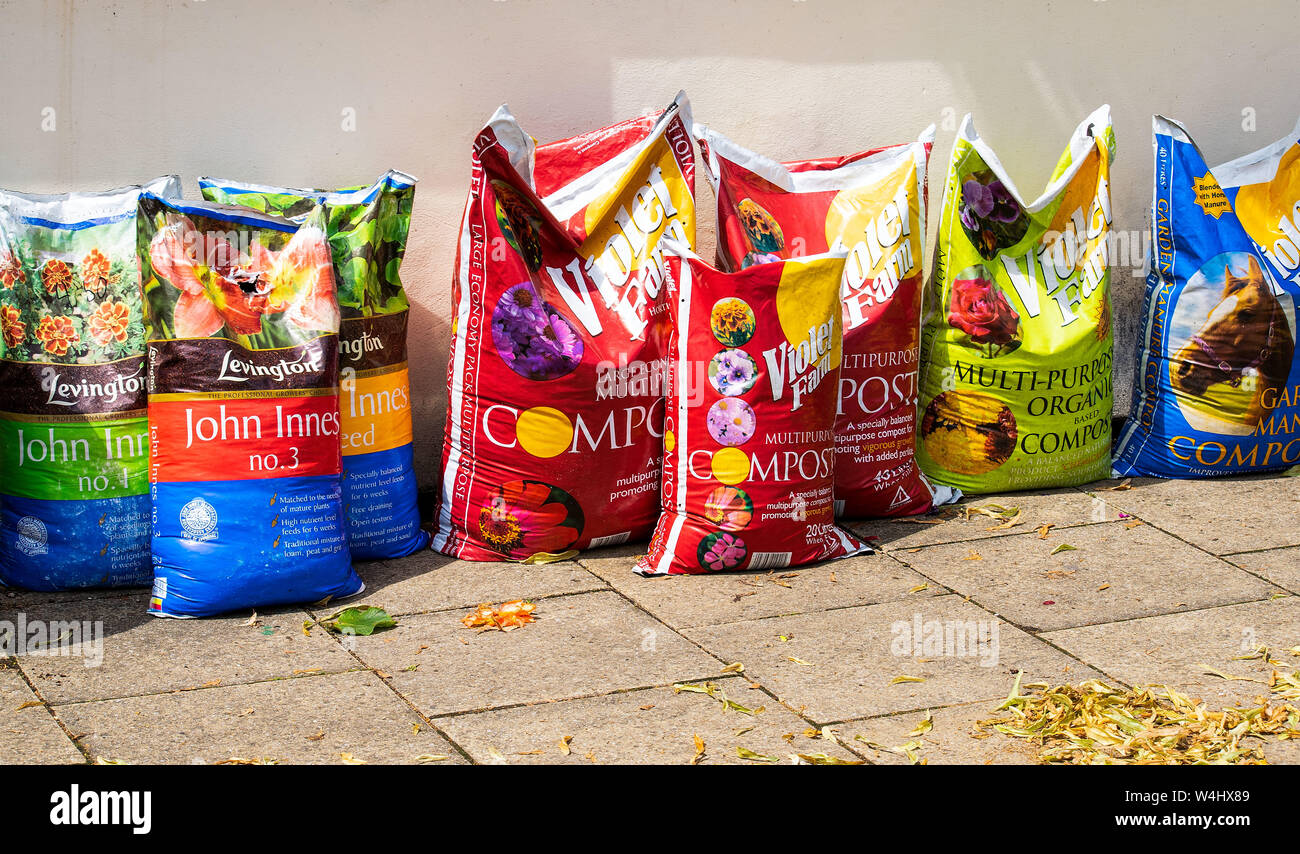 Several bags of different types of potting compost for growing various