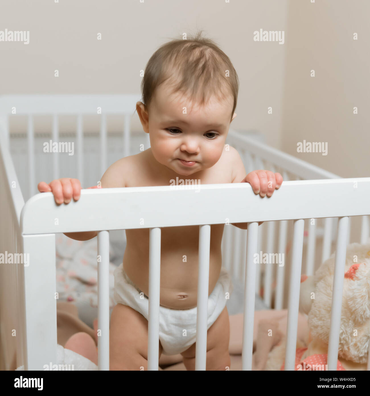 Baby Girl In A Diaper Playing In The Crib Stock Photo 261008081