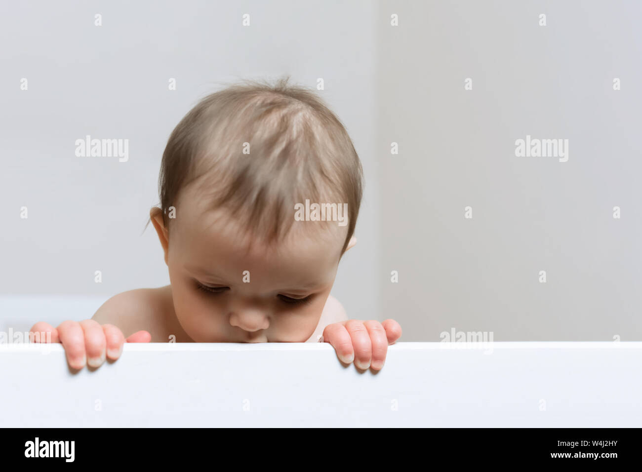 Baby standing up in cot hires stock photography and images Alamy