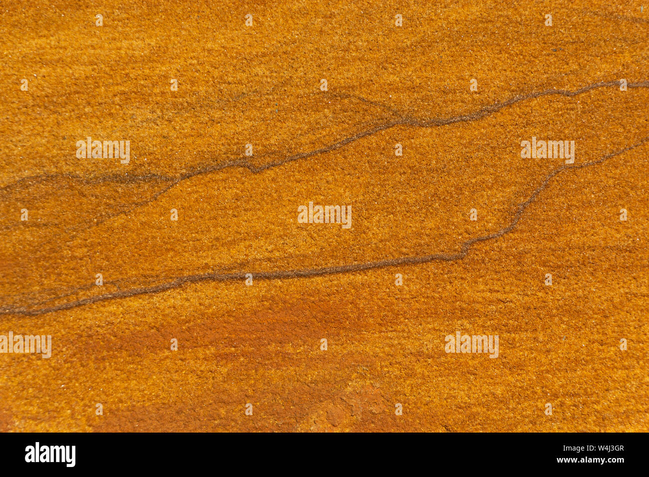 Yellow rough sand stone texture close up background. Stock Photo