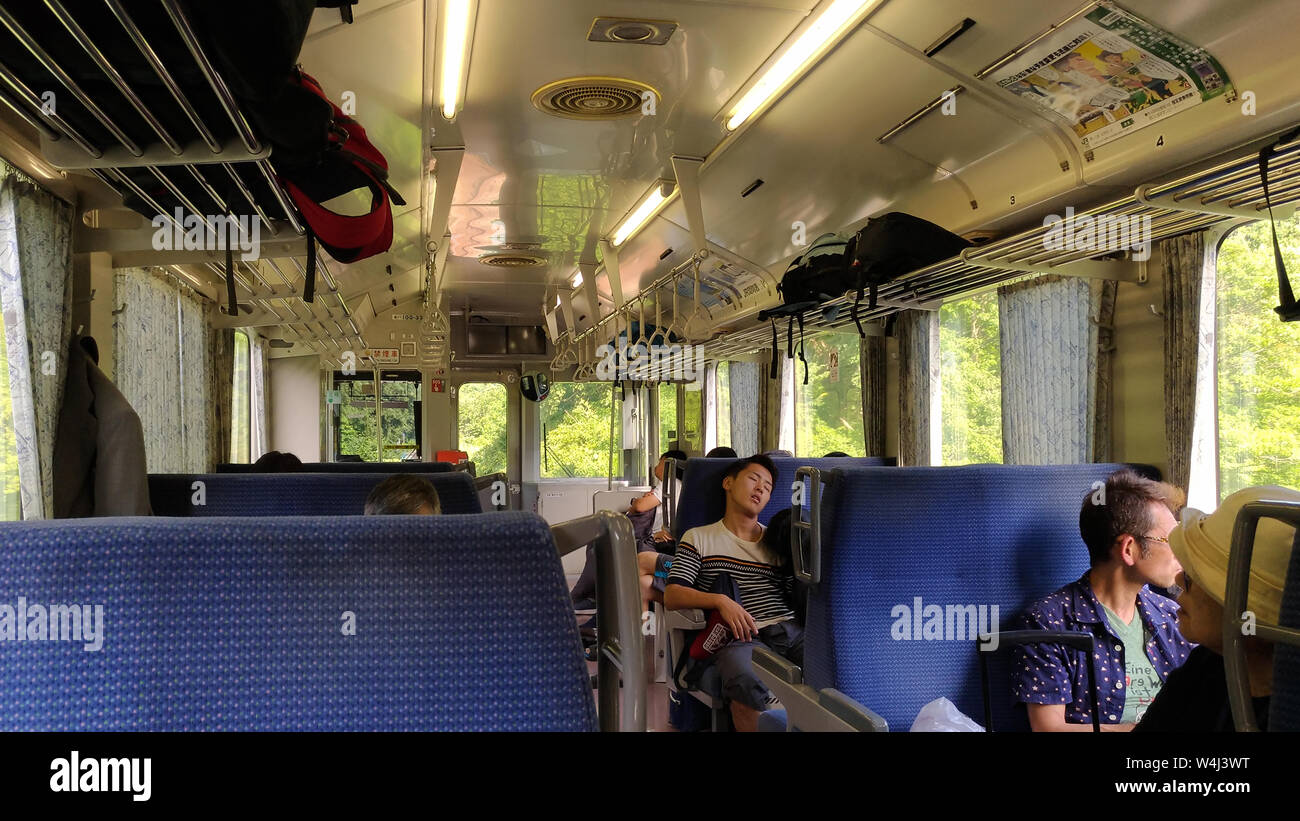 Interior of A local train in Japan. passenger are relaxing in the car Stock Photo