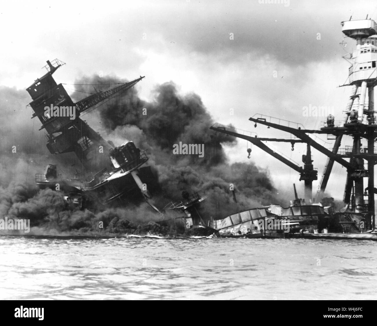 Destroyer USS Arizona, burning in floating drydock at Pearl Harbor after the Japanese attack on Pearl Harbor, Hawaii on December 7th, 1941 Stock Photo