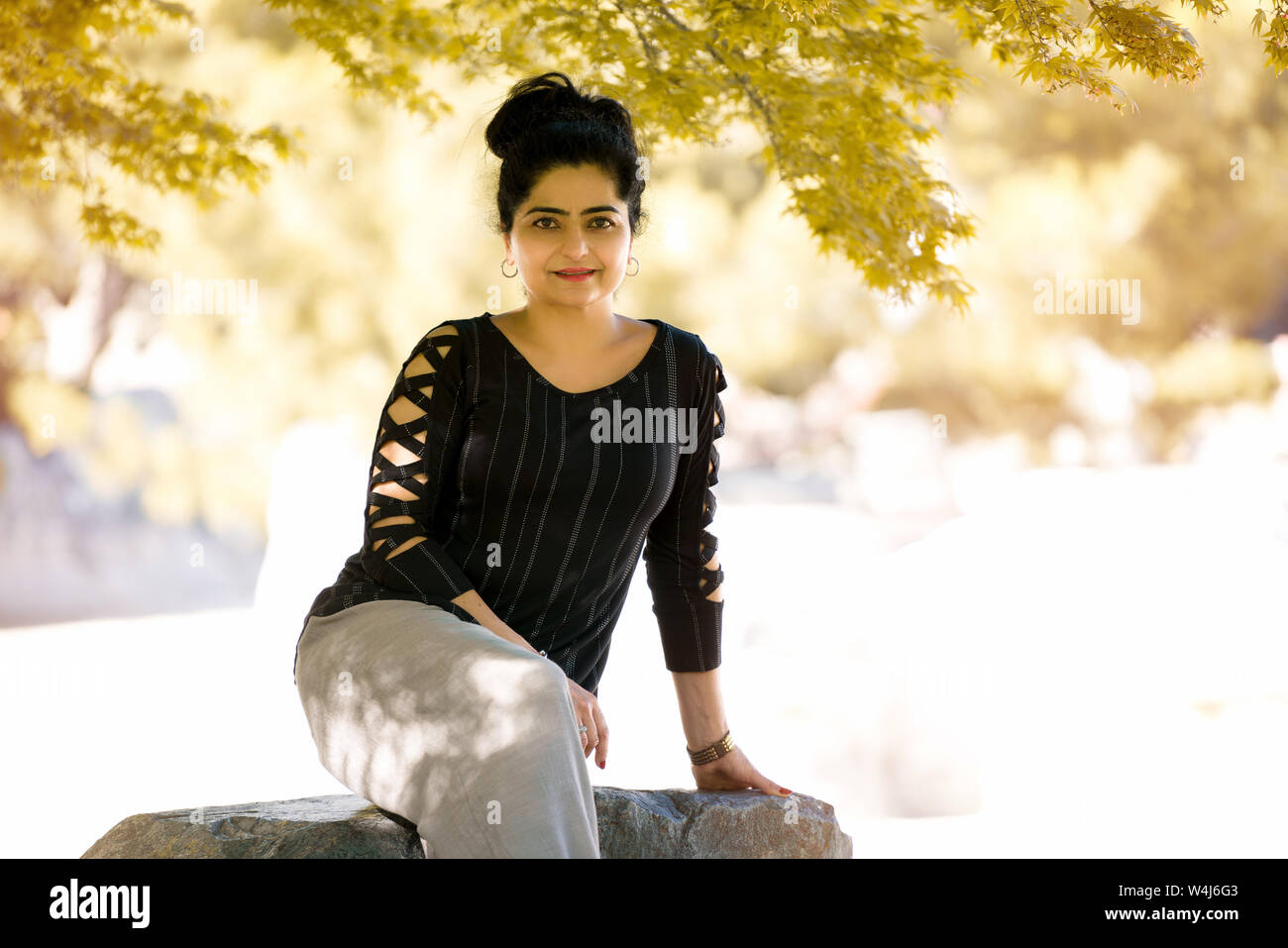 Indian lady in a park hi-res stock photography and images - Alamy