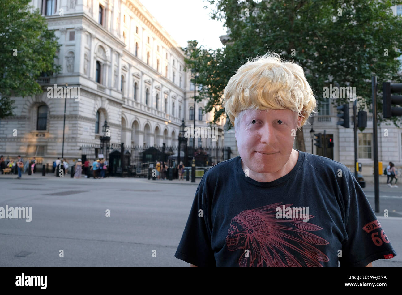 A protester wearing a Boris Johnson's mask and a fake blonde wig outside Downing Street during the rally in London.Protesters gathered outside Downing Street to protest against the announcement of Tory Boris Johnson as a new UK Prime Minister, who was elected only by less than 150,000 members of the Conservative party, a party that doesn’t hold a majority in Parliament. They demanding an immediate general election and launched plans to protest at the Conservative party national conference later this year. Stock Photo