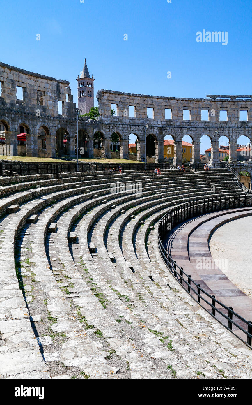 Tourists explore inside Pula Arena, a Roman amphitheatre built in Croatia in the 1st century AD Stock Photo