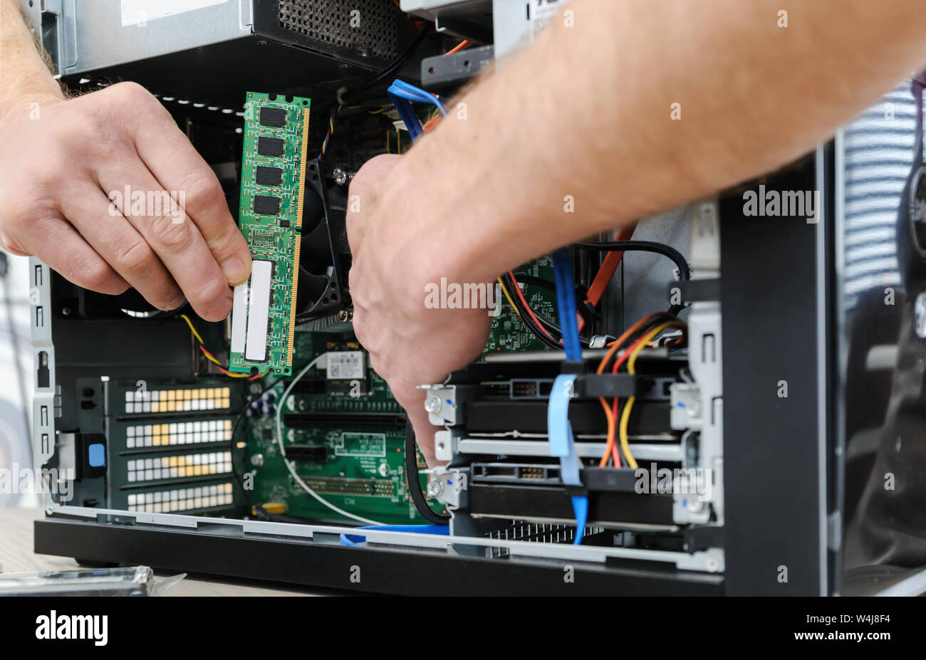 A man is holding a RAM slot to upgrade of the computer. Stock Photo