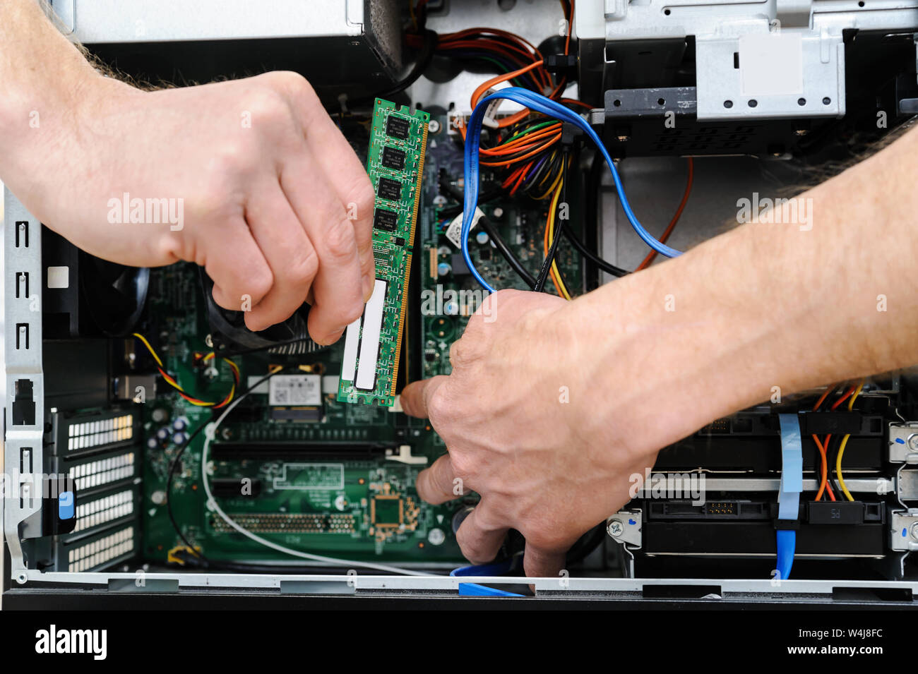 A man is holding a RAM slot to upgrade of the computer. Stock Photo