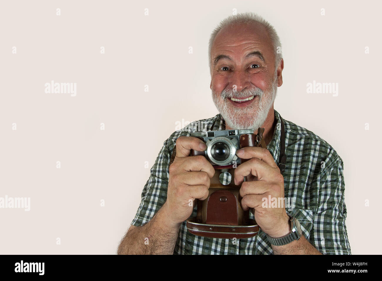 Two that match. Laughing old photographer with his old photo camera. Stock Photo