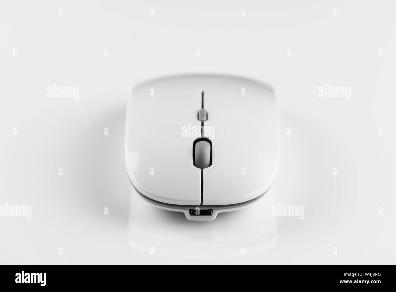 White wireless computer mouse on a white background. Stock Photo