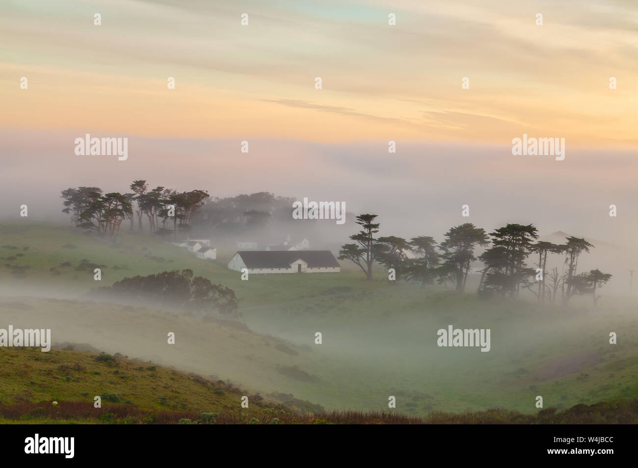 View of the historic Pierce Point Ranch covers in fog at sunrise in Point Reyes National Seashore, California, United States. Stock Photo