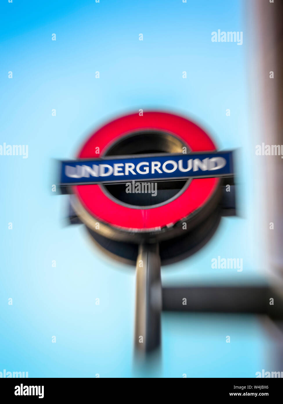 London Underground sign. London, England. The photograph was processed with a motion blur effect. Stock Photo