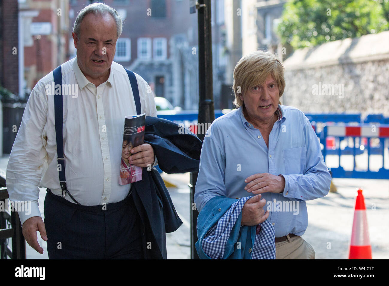 London, UK. 23 July, 2019. James Gray (l), Conservative MP for North Wiltshire, and Michael Fabricant (r), Conservative MP for Lichfield, leave after attending a celebration in Westminster of Boris Johnson’s election as Conservative Party leader and replacement of Theresa May as Prime Minister organised by the pro-Brexit European Research Group (ERG). Credit: Mark Kerrison/Alamy Live News Stock Photo