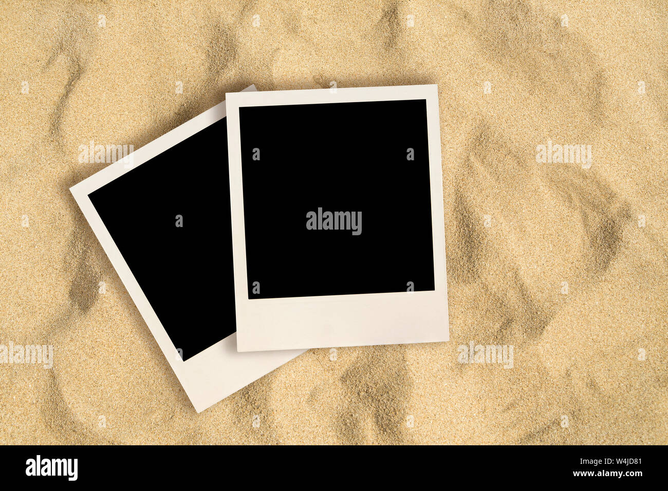 Blank instant images on sand background Stock Photo