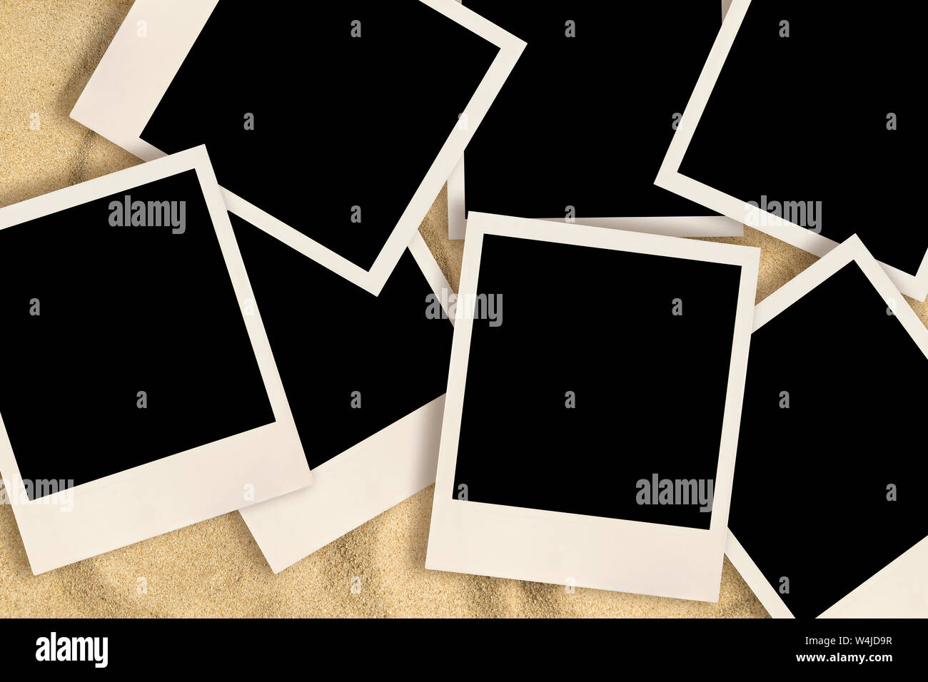 Blank instant images on sand background Stock Photo