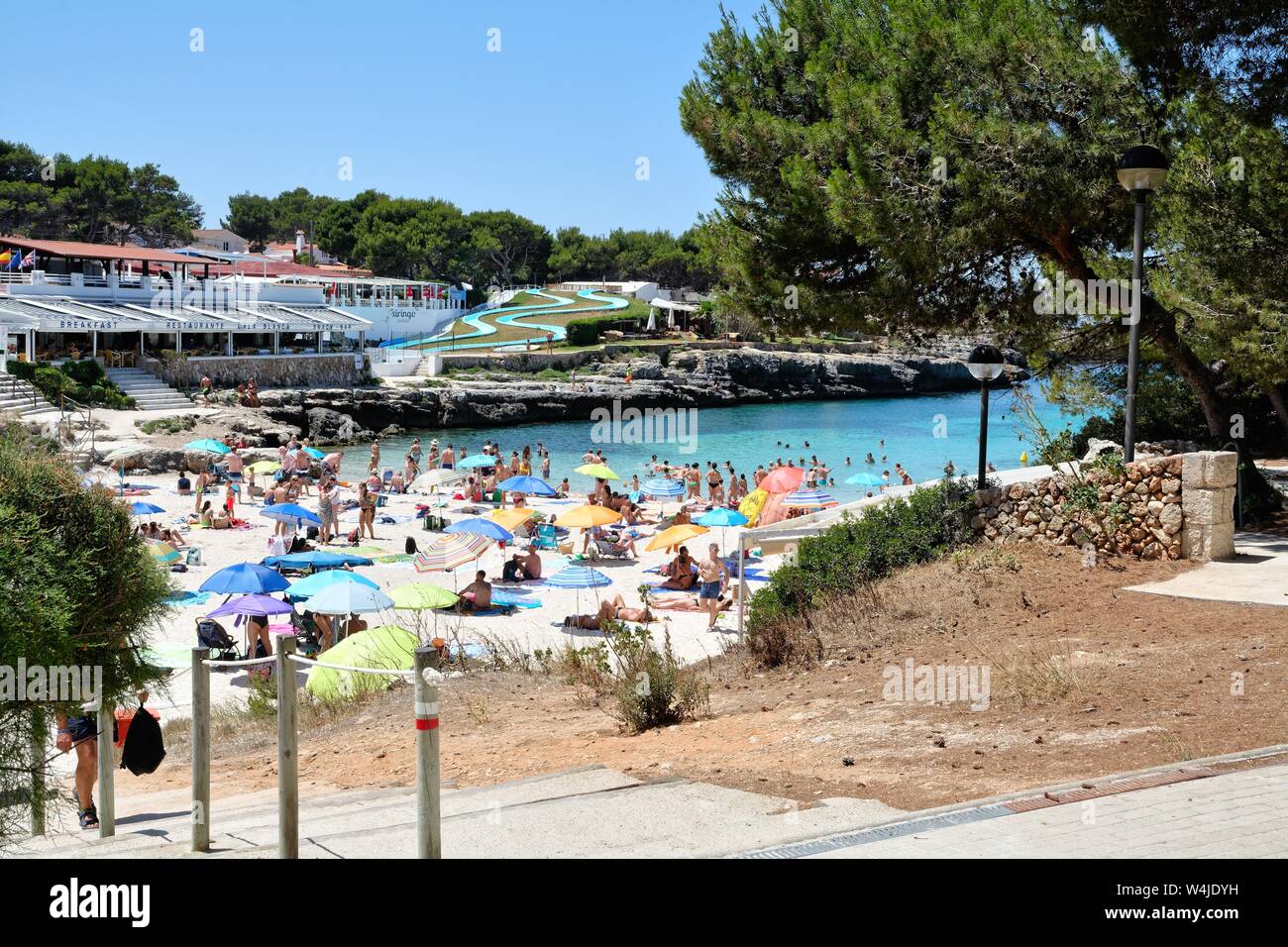 The beach and cove at Cala Blanca on a hot summers day Menorca Balearic Islands Spain Europe Stock Photo